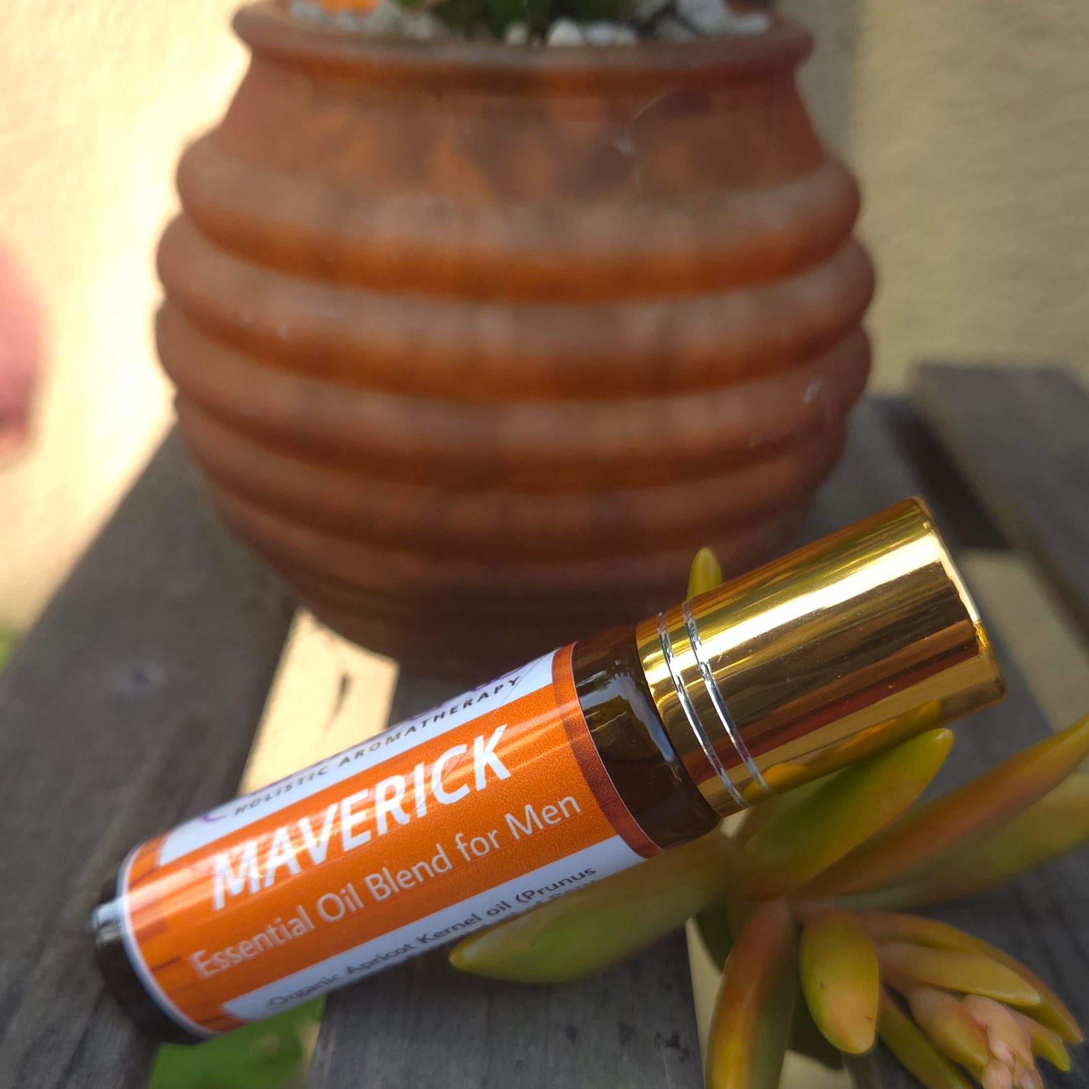 Aromatherapy perfume roll-on for men with a warm, calming fragrance placed beside a decorative pot.