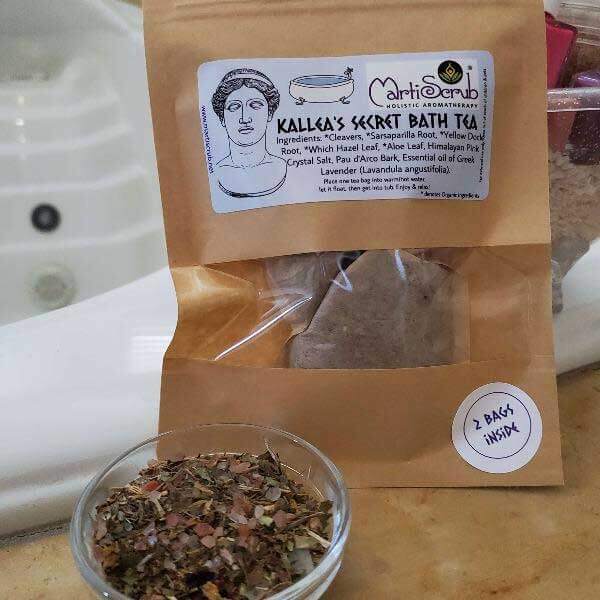 Kallea's Secret Herbal Bath Tea with ingredients and two bags inside, displayed with loose herbs in a bowl.