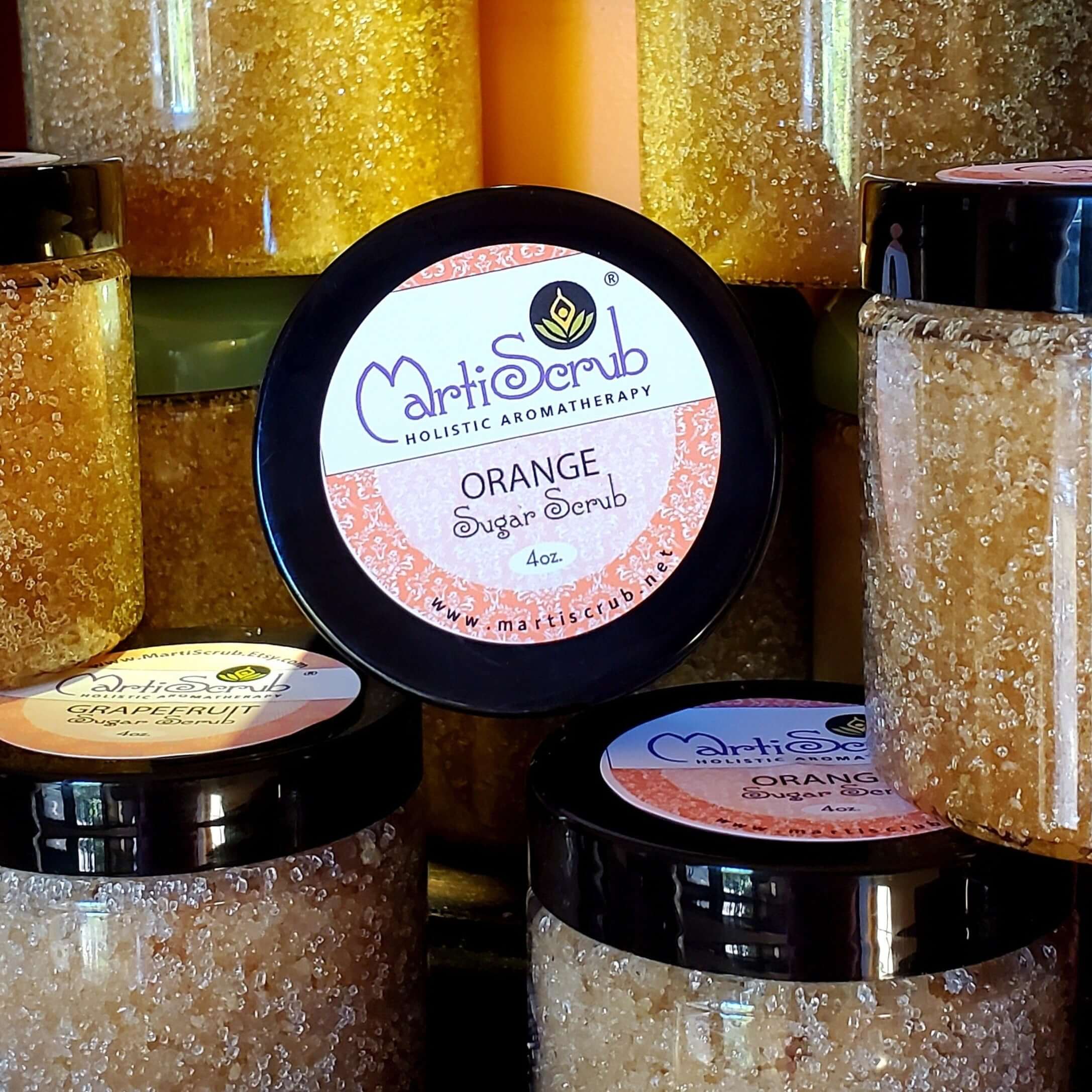 Orange Sugar Scrub jars showcasing organic ingredients, perfect for soft, glowing skin and aromatherapy.