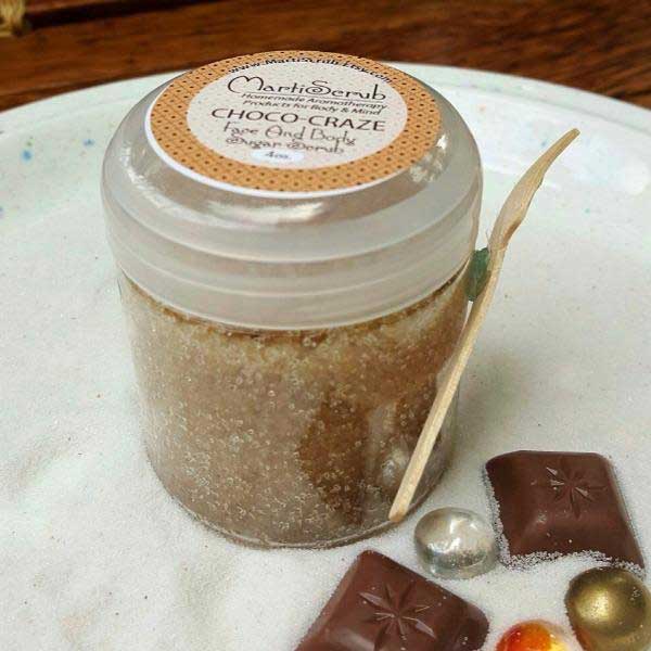 Choco-Craze chocolate sugar scrub jar on a plate, showcasing organic ingredients and a luxurious scent.