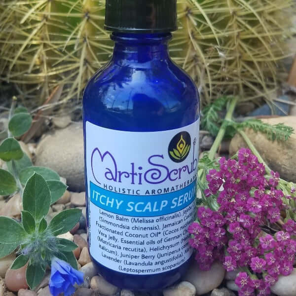 ITCHY SCALP SERUM bottle surrounded by flowers and leaves, promoting scalp nourishment and dandruff relief.