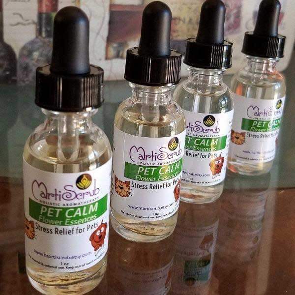 Pet Calm flower essence bottles for stress relief in pets on a wooden surface.