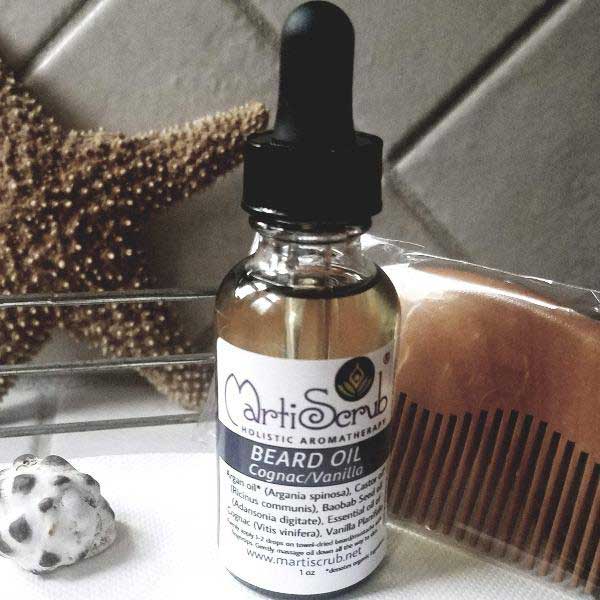 Beard oil bottle with dropper and peachwood comb, featuring organic Argan and Baobab seed oils for nourishment.